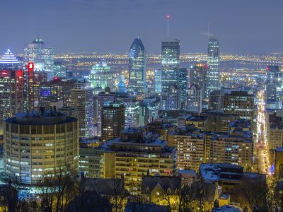 Downtown Montreal skyline illuminated at night with modern skyscrapers, city lights, and urban views in the heart of Montreal.