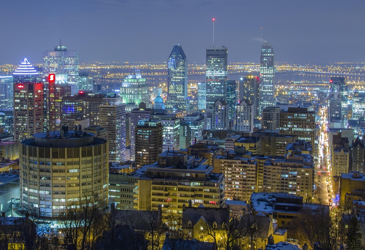 Downtown Montreal skyline illuminated at night with modern skyscrapers, city lights, and urban views in the heart of Montreal.